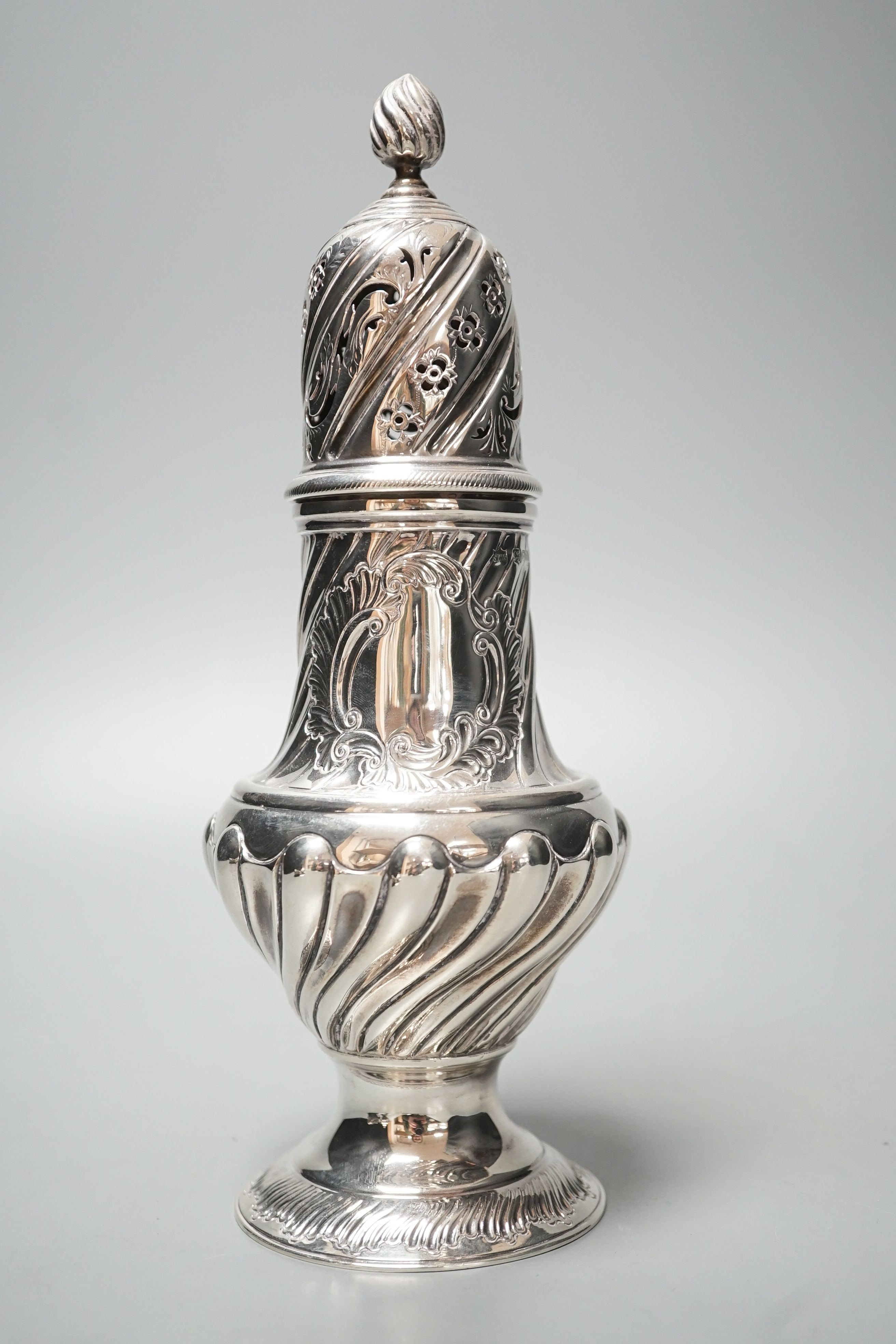 A large Victorian repousse silver sugar caster, London, 1887, 22.7cm, 8.5oz.